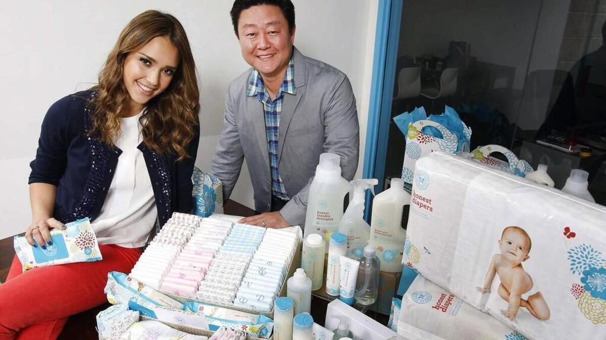 Jessica Alba, left, and Brian Lee, right, pose for a photo on Feb. 1, 2012, at the Santa Monica, Calif., headquarters of Honest.com.