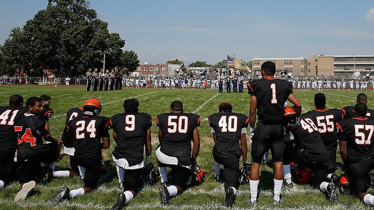 Some high school students, like these students in Camden, N.J., are kneeling during the national anthem in protest of injustice. A Lousiana school district says it will punish students who do the same.