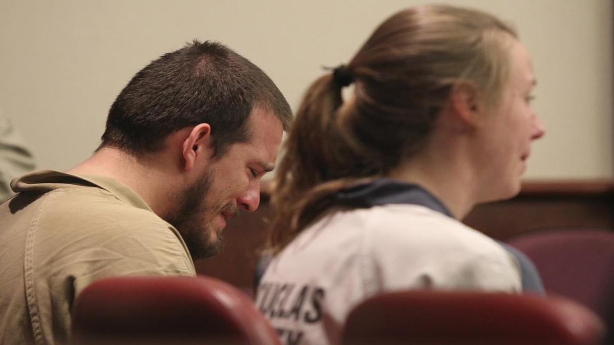 Jose Torres, left, weeps during his sentencing at the Douglas County Courthouse in Douglasville, Ga., Monday, Feb. 27, 2017. Superior Court Judge William McClain sentenced Torres and Kayla Norton, right, to lengthy prison terms Monday for their role in the disruption of a black child's birthday party with Confederate flags, racial slurs and armed threats.