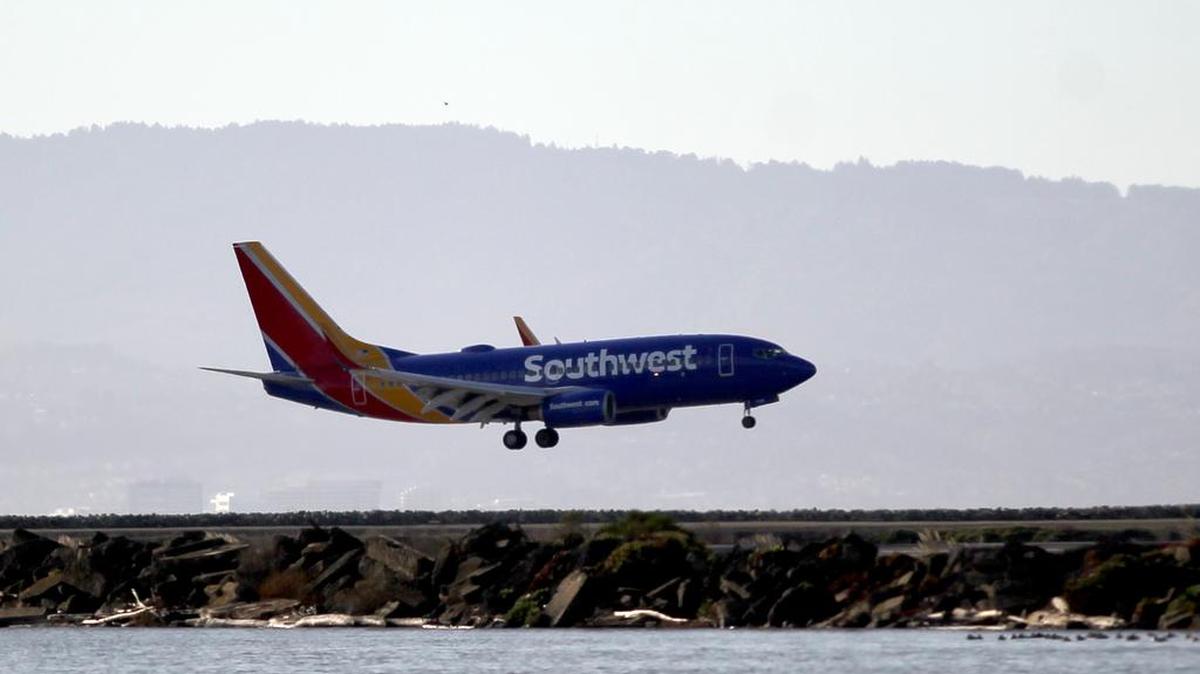 Southwest Airlines Flight 2547 makes an emergency landing after circling for several hours at Oakland International Airport in Oakland, Calif., on Wednesday, Dec. 23, 2015.