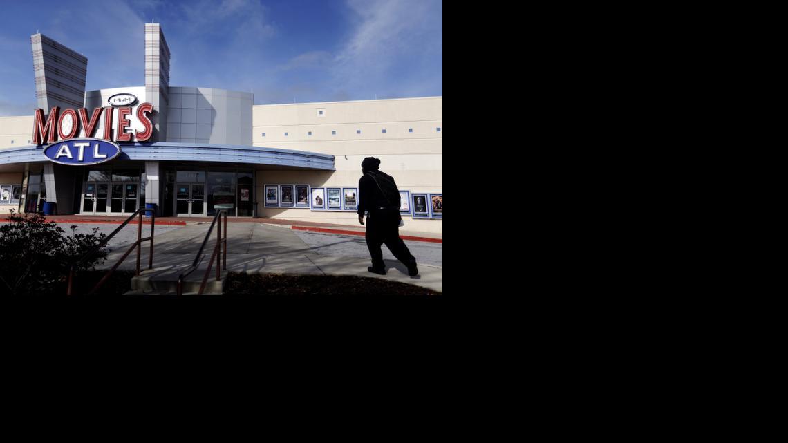 
A patron walks into a Carmike Cinemas movie theater, Wednesday, Dec. 17, 2014, in Atlanta. 
