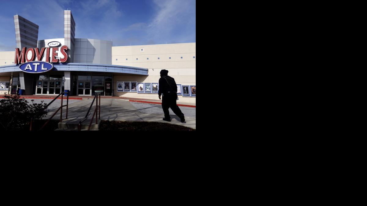 
A patron walks into a Carmike Cinemas movie theater, Wednesday, Dec. 17, 2014, in Atlanta. 
