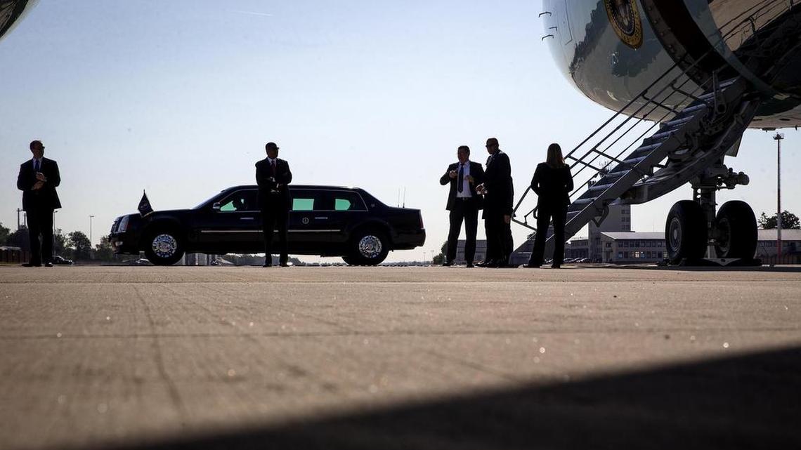 Members of the Secret Service stand at the steps of Air Force One during a refueling stop at Ramstein Air Base in Germany, July 24, 2015.
