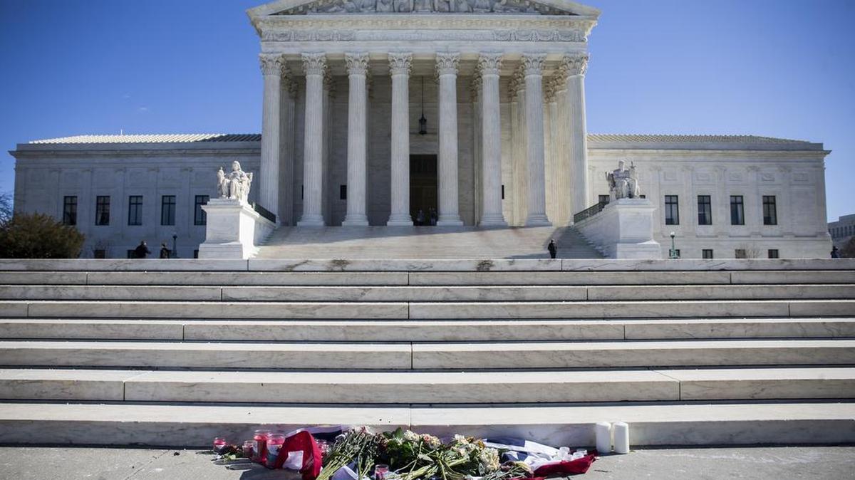 Flowers and candles are laid outside the U.S. Supreme Court in Washington following the death of Justice Antonin Scalia.
