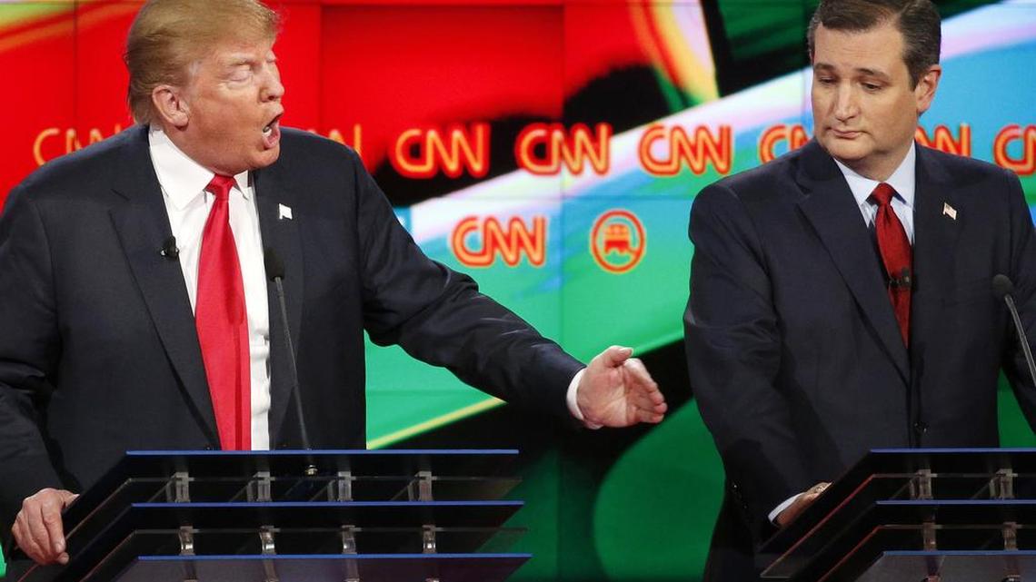 Donald Trump, left, responds to Jeb Bush (not shown) in a debate as Ted Cruz looks on.
