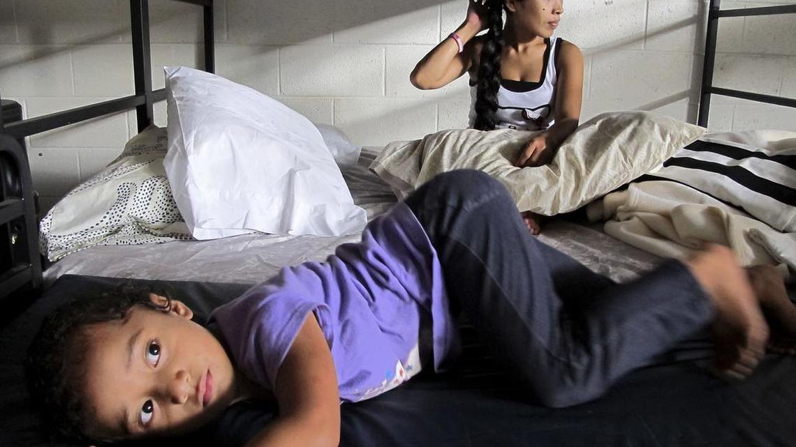 Keioleen Helly, 3, foreground, and her aunt, Kifency Kinny, 24, lay on a bed in the Institute for Human Services family shelter in Honolulu. New figures released by the federal Department of Housing and Urban Development show a drop in national numbers of homeless people.
