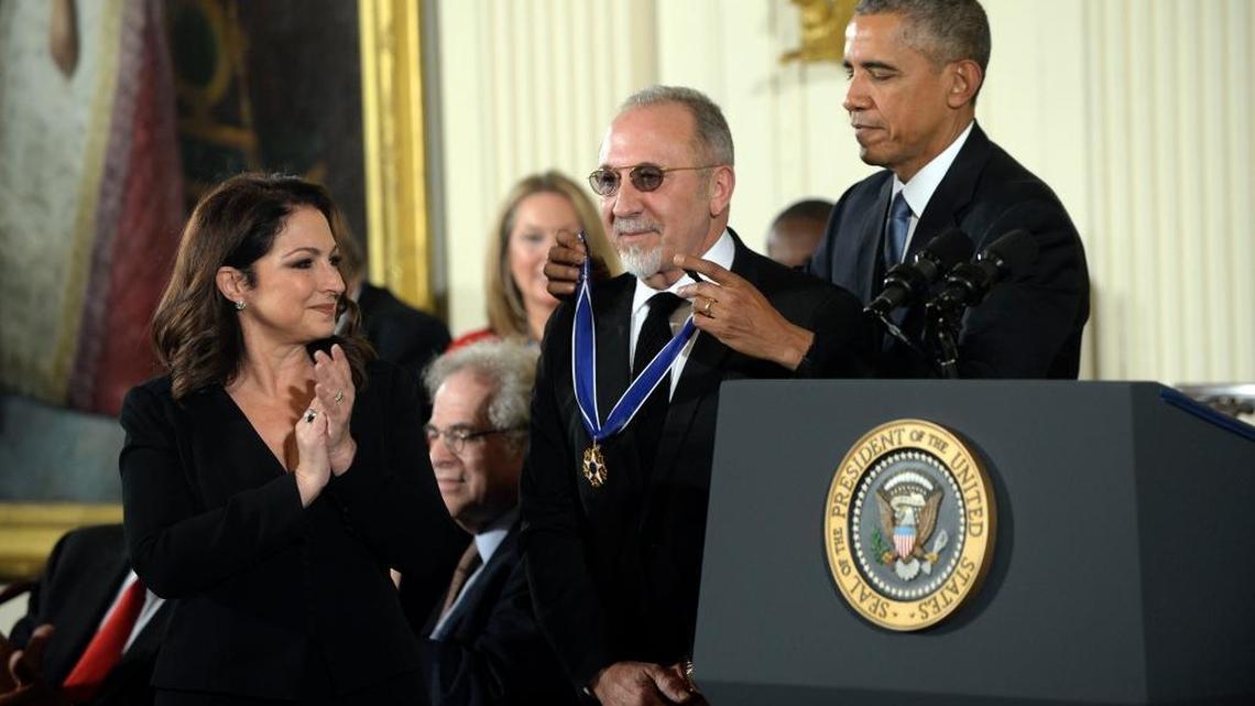 U.S. President Barack Obama gives the Presidential Medal of Freedom to music producer Emilio Estefan, before giving one to his wife, singer Gloria Estefan, in the East Room of the White House on Nov. 24, 2015, in Washington, D.C.