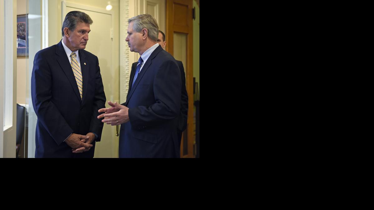 
Sen. Joe Manchin, D-W.Va., left, talks with Sen. John Hoeven, R-N.D., on Capitol Hill in Washington, Tuesday, Jan. 6, 2015, before their news conference to discuss their plan to introduce legislation to approve the Keystone XL pipeline project.
