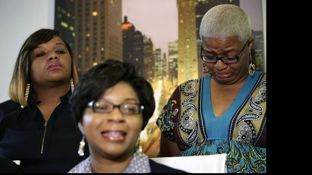 
Sandra Bland's sisters Sharon Cooper, front, takes questions from the media, while her sisters Shavon Bland, left, and Shante Needham become emotional, during a news conference about their sister's death Thursday in Chicago. Sandra Bland, a 28-year-old woman who authorities say hanged herself in a Texas jail after her arrest for allegedly kicking an officer following a traffic stop gave no indication she was in such an emotional state that she would kill herself, her sister said Thursday.
