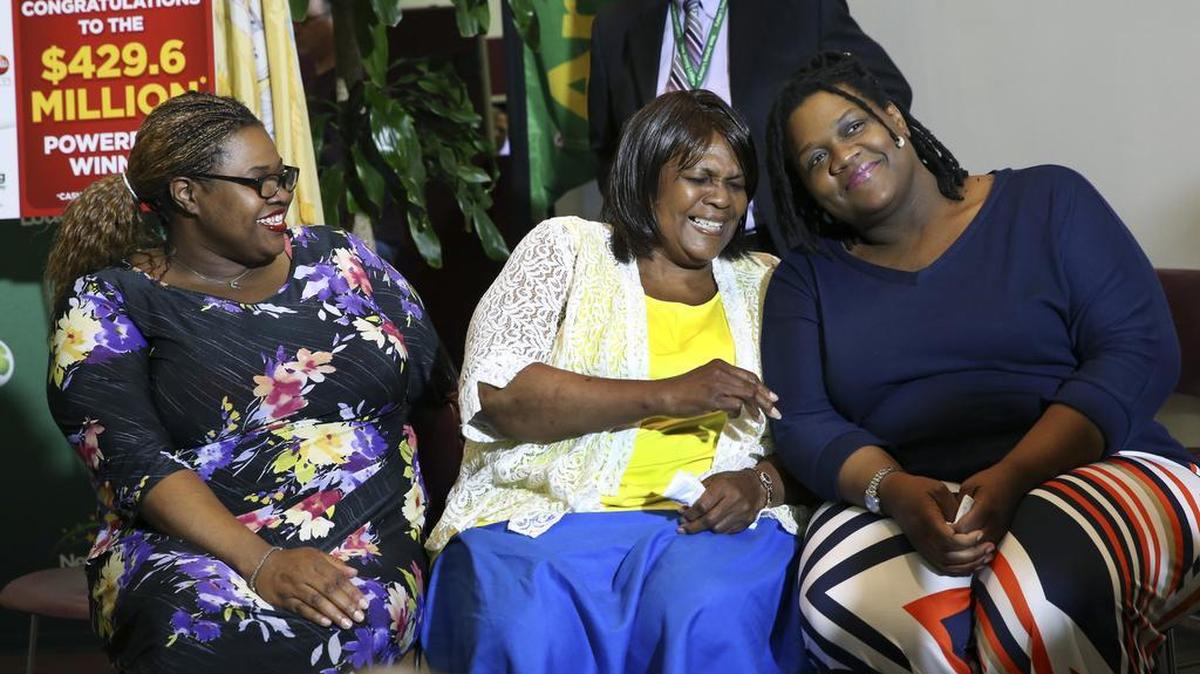 Pearlie Mae Smith, second right, reacts as she sits with daughters Rene Bethina Smith, third right, and Katherine Nicole Nunnally, right last year after winning the jackpot.