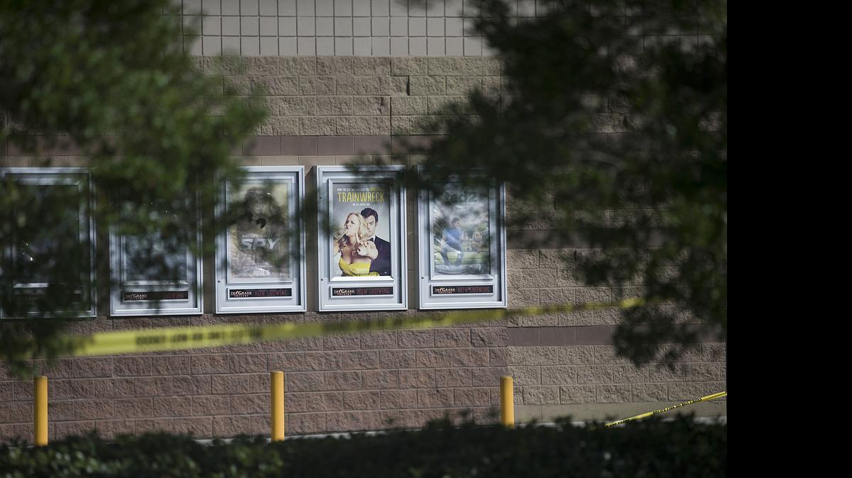 
A movie poster for "Trainwreck" hangs with police tape surrounding it at the Grand Theater following a deadly shooting, July 24, 2015, in Lafayette, La. John Russell Houser stood up about 20 minutes into the showing of "Trainwreck" and fired on the audience with a semi-automatic handgun. 
