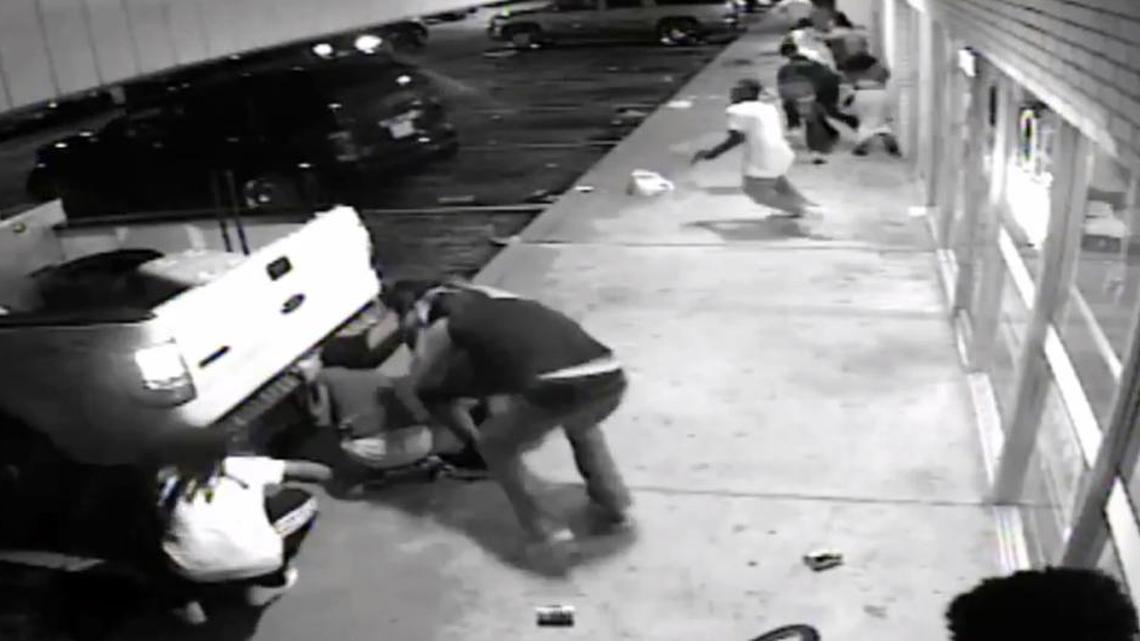 
In this frame from surveillance video provided by the St. Louis County Police shows the 18-year-old black suspect, center in light colored clothes, minutes before he fired a gun at plainclothes officers in Ferguson, Mo., on Sunday. Tyrone Harris Jr. was shot late Sunday after police say he opened fire on an unmarked police van. The shooting happened as protesters nearby were marking the anniversary of the shooting death of Michael Brown, who was killed by a white police officer.
