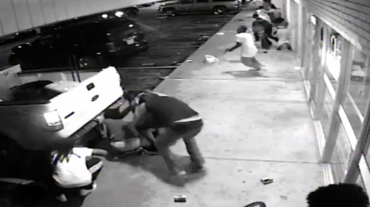 
In this frame from surveillance video provided by the St. Louis County Police shows the 18-year-old black suspect, center in light colored clothes, minutes before he fired a gun at plainclothes officers in Ferguson, Mo., on Sunday. Tyrone Harris Jr. was shot late Sunday after police say he opened fire on an unmarked police van. The shooting happened as protesters nearby were marking the anniversary of the shooting death of Michael Brown, who was killed by a white police officer.
