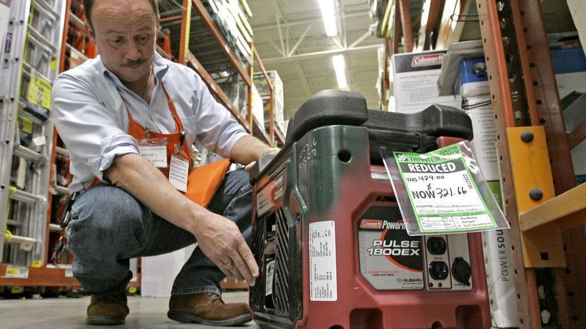 Hardware supervisor Dwayne Shope, demonstrates features on a floor model generator at a Home Depot store in Orlando, Fla., Thursday, May 17, 2007. The federal government is now requiring that all new portable generators carry a warning about the hazards of carbon monoxide poisoning.