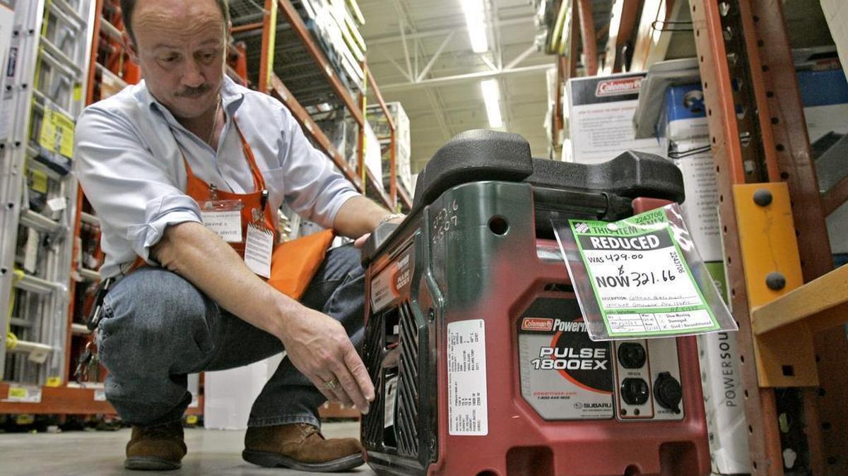 Hardware supervisor Dwayne Shope, demonstrates features on a floor model generator at a Home Depot store in Orlando, Fla., Thursday, May 17, 2007. The federal government is now requiring that all new portable generators carry a warning about the hazards of carbon monoxide poisoning.