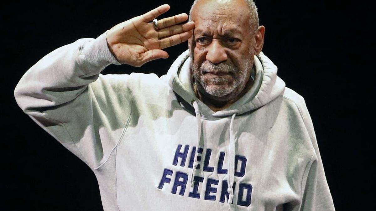 
Comedian Bill Cosby salutes the crowd as he begins a performance at the Buell Theater in Denver in January 2015. A year after allegations of sexual assault resurfaced and snowballed, women who’ve accused him of sexual assault are giving emotional interviews en masse, judges are ruling against him, and colleges are continuing to revoke honorary degrees bestowed upon him when he was one of the country’s most admired entertainers.
