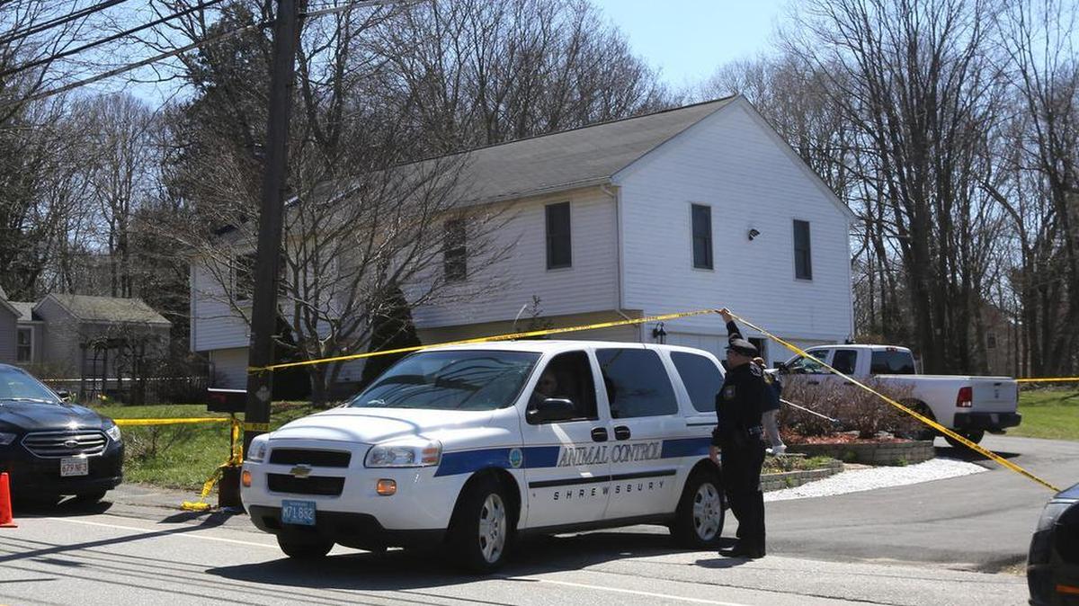 An animal control officer leaves the scene as police investigate a suspicious death in a home on Worcester Street in Grafton, Mass., April 13, 2016.