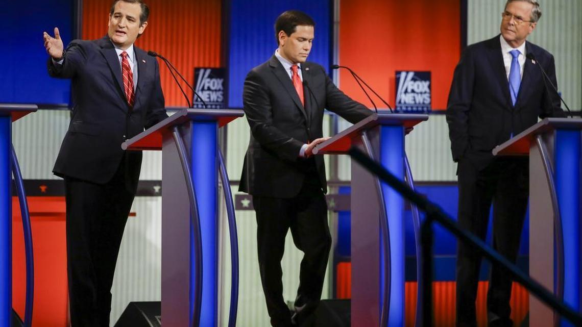 Sen. Ted Cruz, R-Texas (from left), answers a question as Sen. Marco Rubio, R-Fla., listens and former Florida Gov. Jeb Bush looks on during a Republican presidential primary debate, Thursday, Jan. 28, 2016, in Des Moines, Iowa.