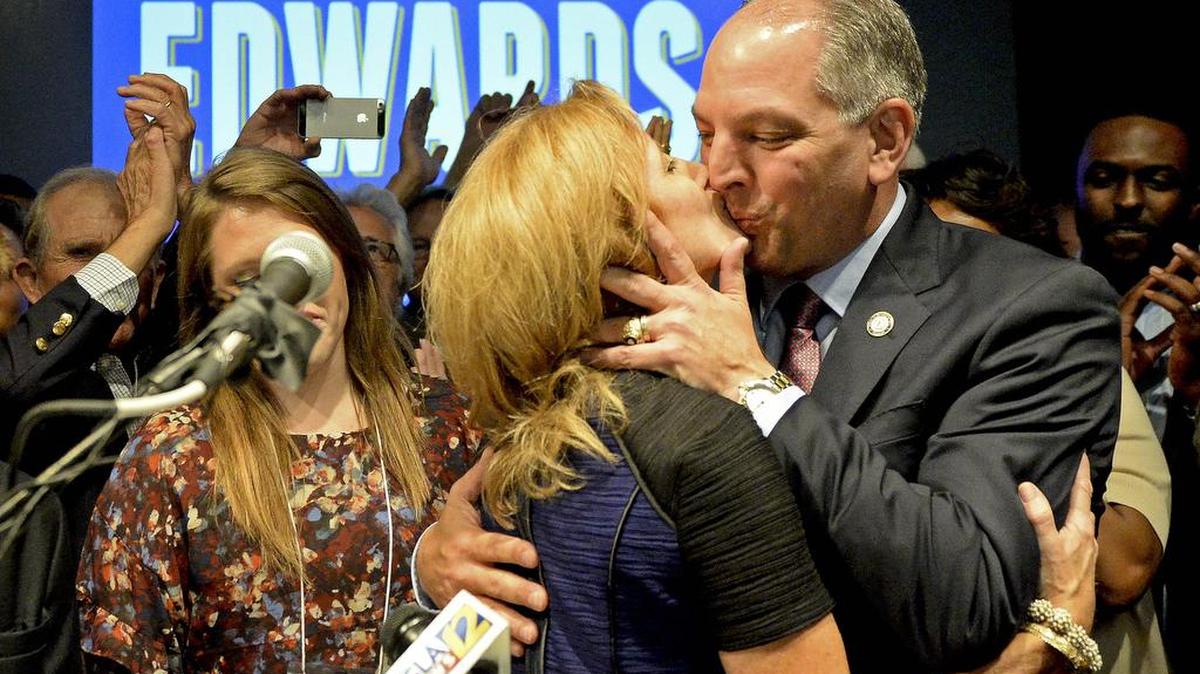 Democrat John Bel Edwards gives his wife, Donna, a congratulatory kiss before addressing the crowd Saturday, in downtown Baton Rouge, La. Edwards faces Republican David Vitter in a runoff in the gubernatorial race.