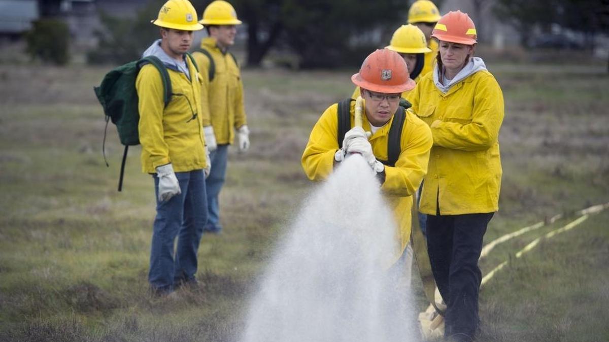 Tyron Demesa, a member of the Army National Guard, learns how to use a fire hose during a training exercise Jan. 14, 2016, in Sacramento, California. The U.S. Forest Service and Work for Warriors, an arm of the California National Guard, work together to train veterans and reservists.