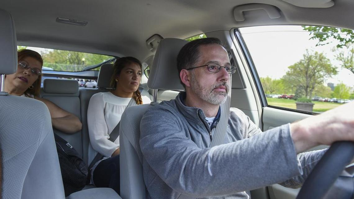 Hearing-impaired Uber driver Wendell Pratt takes Gisela Pacheco, left, and Julieth Cruz, both from Boston, to Capitol Hill.