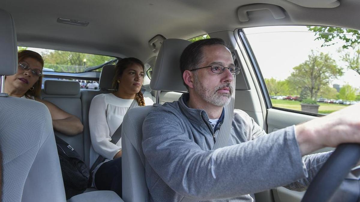 Hearing-impaired Uber driver Wendell Pratt takes Gisela Pacheco, left, and Julieth Cruz, both from Boston, to Capitol Hill.