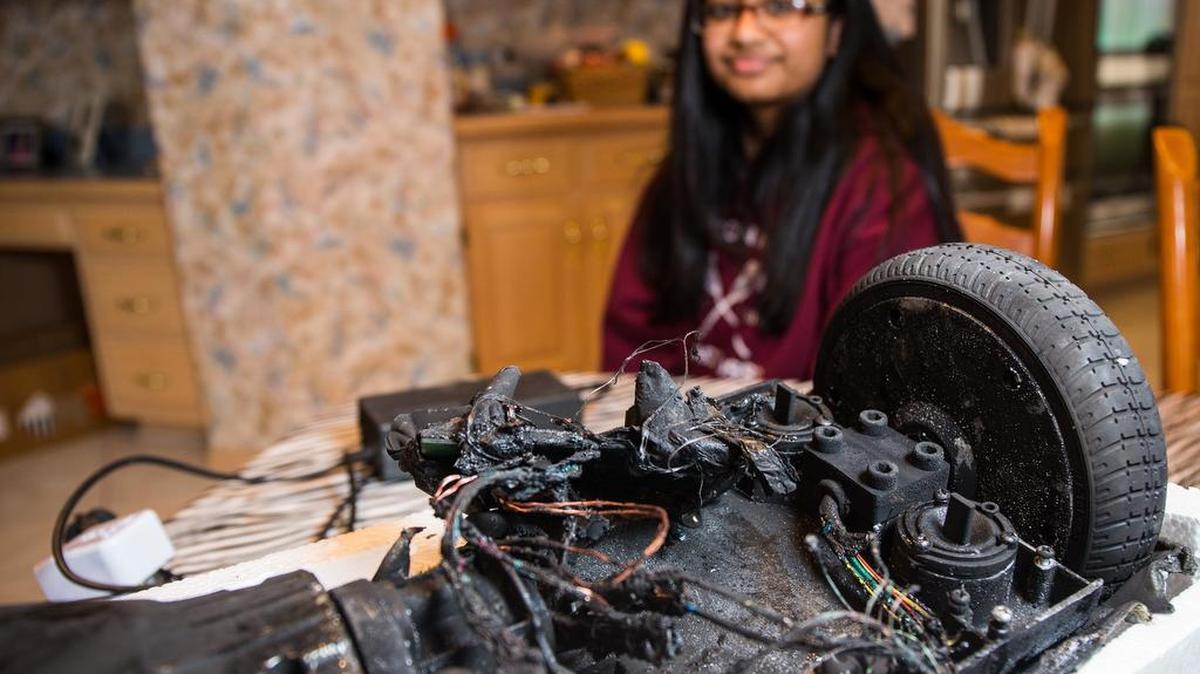 Shanna Abraham, 13, with the remains of her hoverboard at her home in Orland Park, Ill., on Monday. The hoverboard exploded over the weekend while charging, causing minor damage to her family’s home. The U.S. Consumer Product Safety Commission said Friday that hoverboards can be a fire hazard and will go after companies that make, sell, import or distribute hoverboards that don’t meet safety standards.