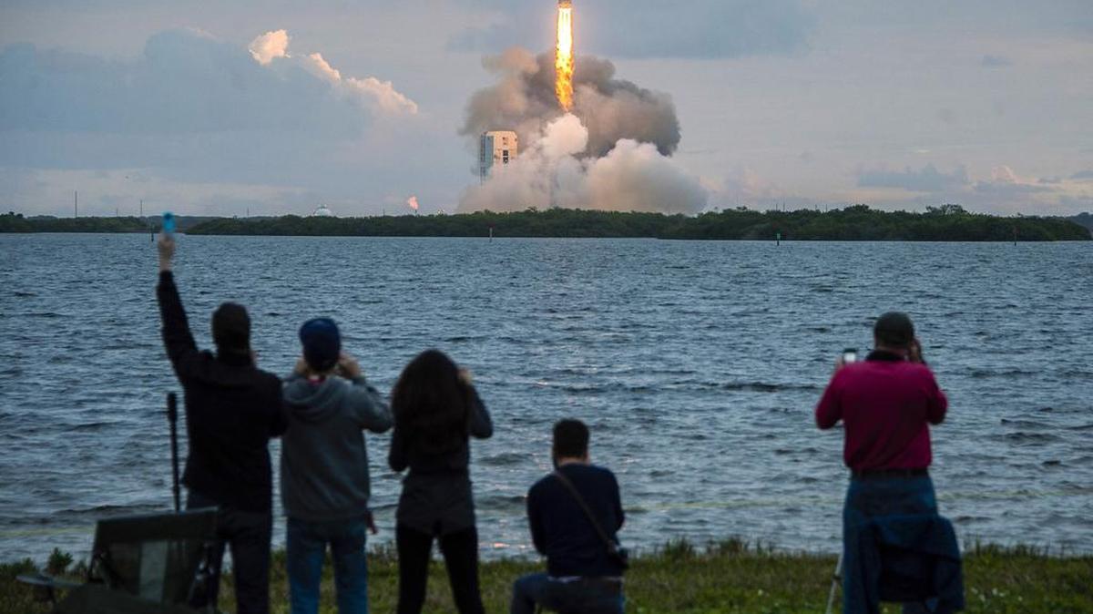 Spectators cheer as the United Launch Alliance Delta 4-Heavy rocket, with NASA’s Orion spacecraft mounted atop, lifts off from the Cape Canaveral Air Force Station, Friday, Dec. 5, 2014, in Cape Canaveral, Fla.