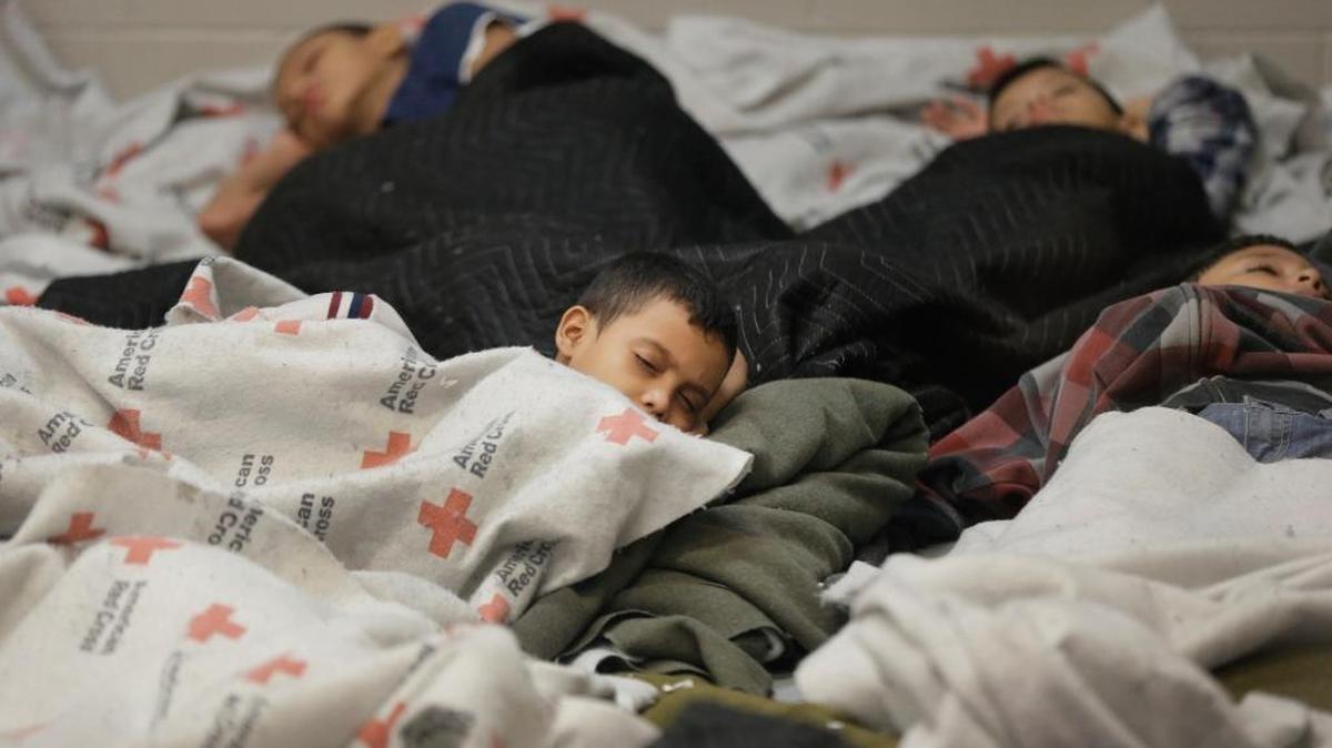 In this June 18, 2014, photo, children who’d been detained at the U.S. border slept at a processing facility in Brownsville, Texas. Fiscal year 2016 is on track to set a record for the number of families from Central America trying to cross the U.S. border.