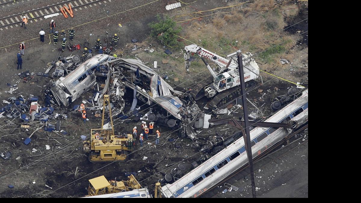 
In this aerial photo, emergency personnel work at the scene of a deadly train wreck, May 13, 2015, in Philadelphia. Federal investigators have arrived to determine why an Amtrak train jumped the tracks in a wreck that killed at least six people, and injured dozens. 
