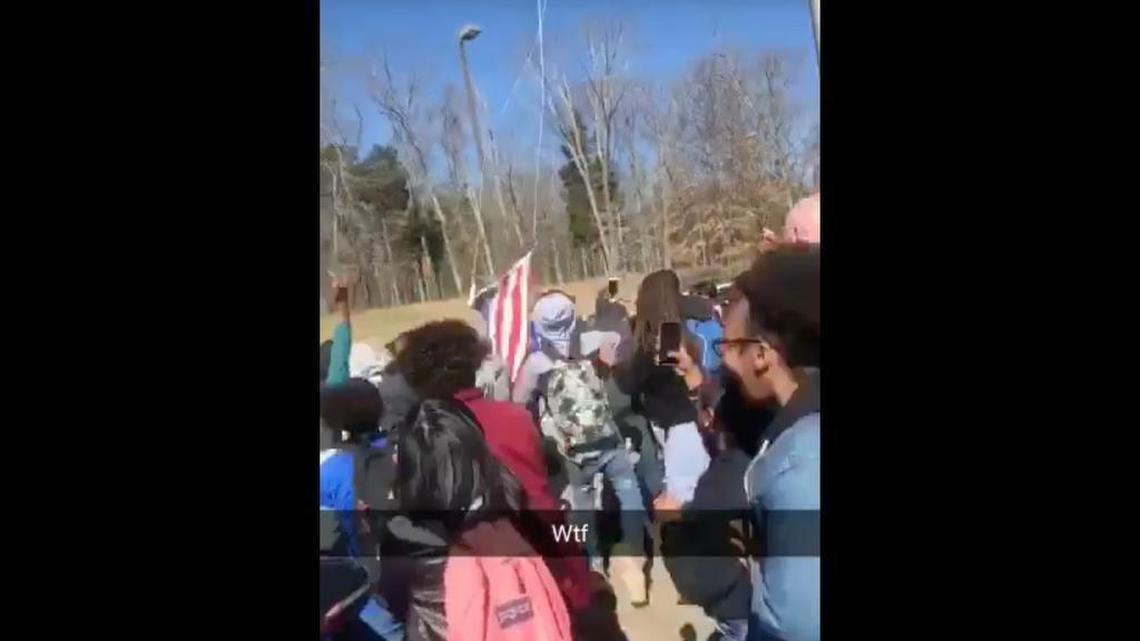 Nashville police say students jumped on a police car and tore down a flag during a walkout at Antioch High School.