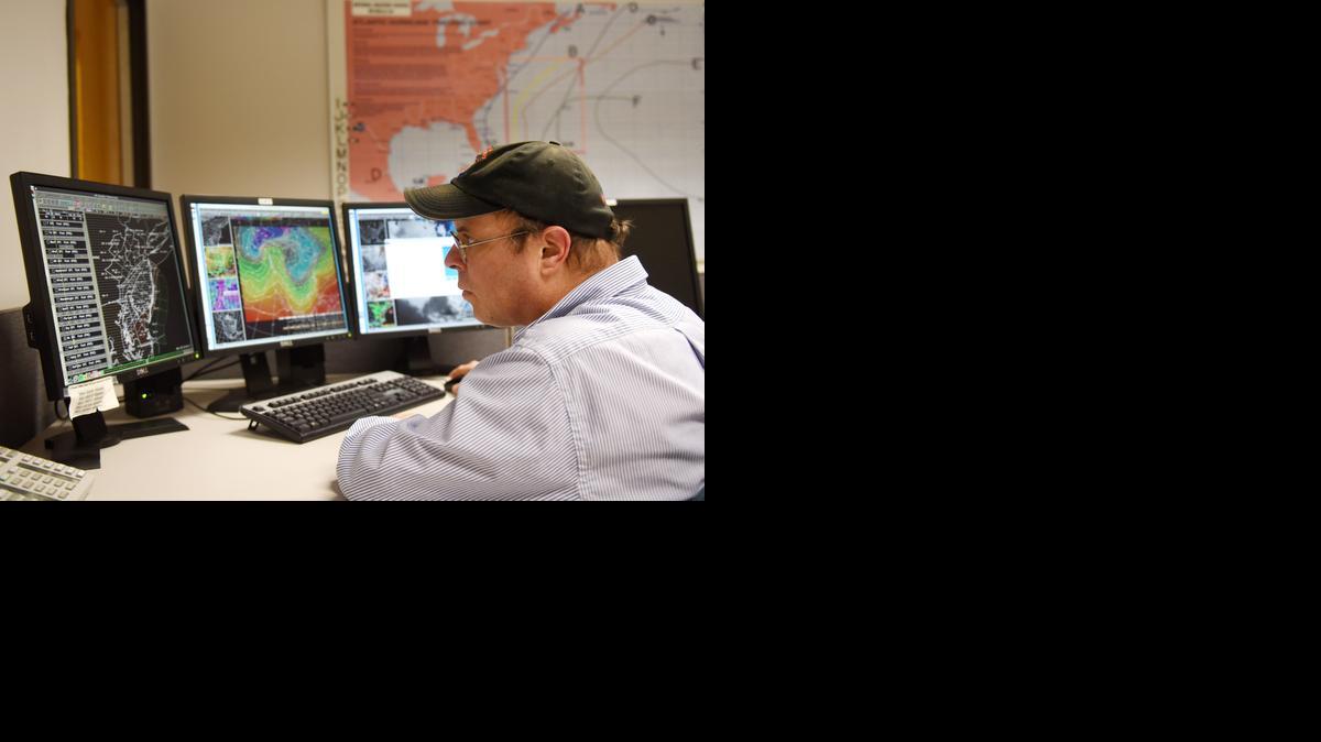 
Meteorologist Anthony Gigi and colleagues work on the weather report Tuesday, Jan. 27, 2015, at the Mt. Holly National Weather Service control room in Mt. Holly, N.J. 
