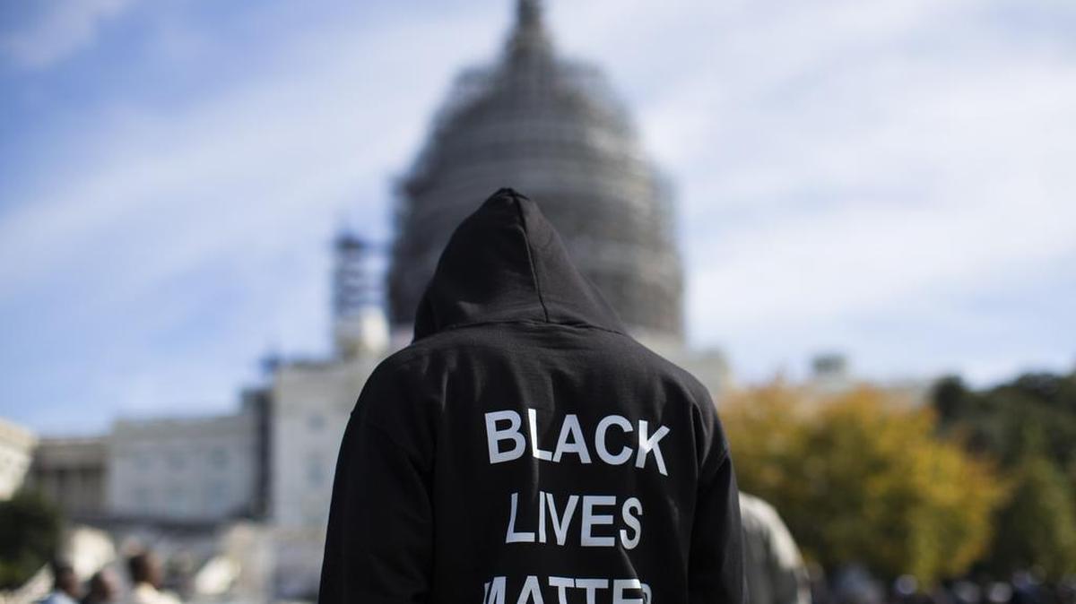 
Neal Blair, of Augusta, Ga., stands on the lawn of the Capitol building during a rally to mark the 20th anniversary of the Million Man March on Saturday, Oct. 10, 2015. 
