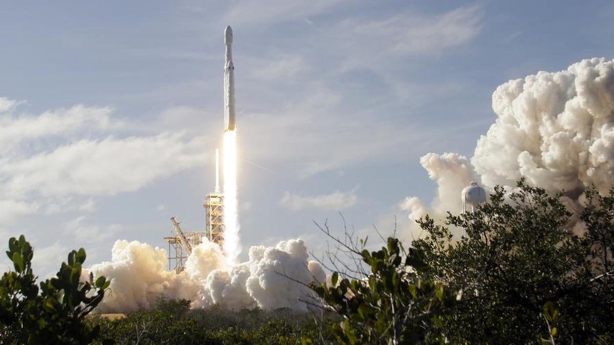 A Falcon 9 SpaceX heavy rocket lifts off from pad 39A at the Kennedy Space Center in Cape Canaveral, Fla., Tuesday. The Falcon Heavy, has three first-stage boosters, strapped together with 27 engines in all.