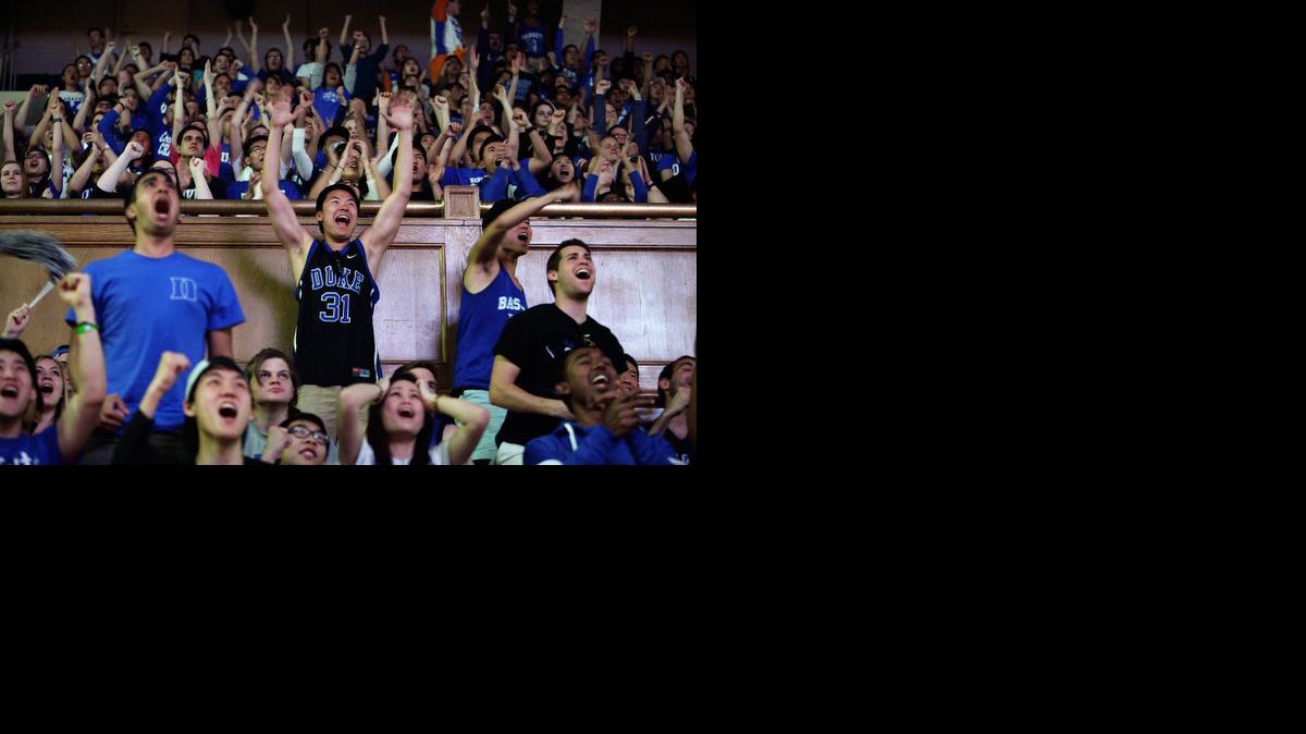 
Duke students and employees, including senior Frank Cai, center, watch a broadcast at Cameron Indoor Stadium, in Durham, N.C., of the NCAA Final Four college basketball game between Duke and Michigan State, Saturday, April 4, 2015. 
