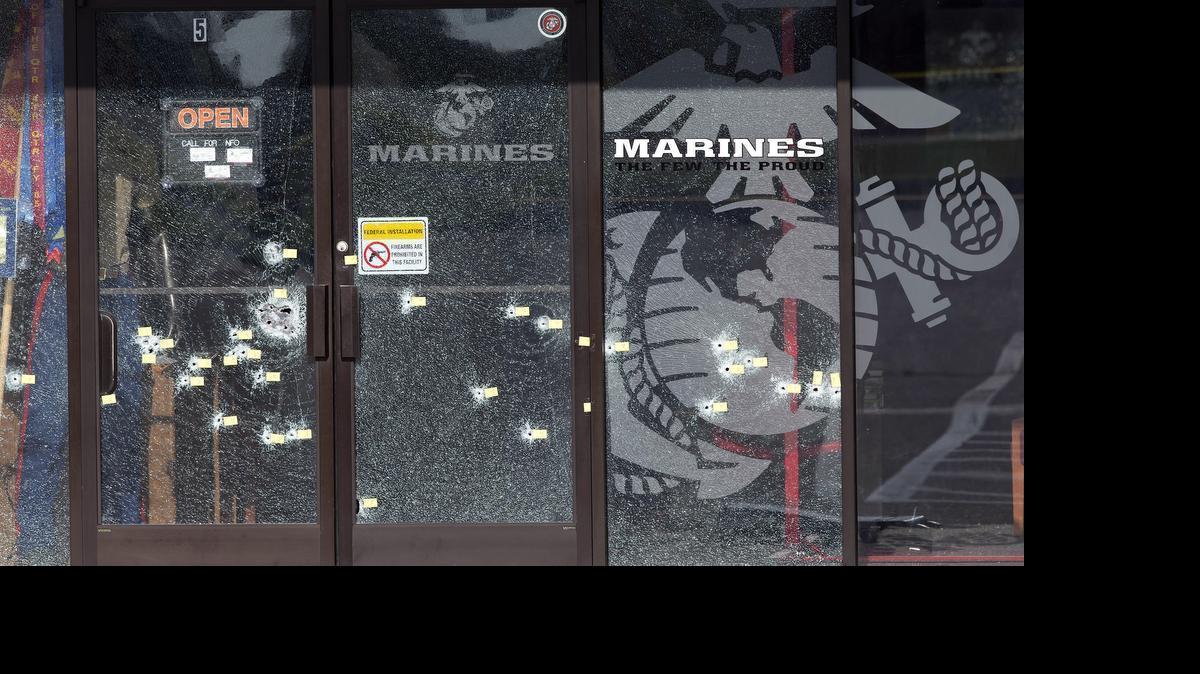 
Yellow pieces of paper mark bullet holes in the glass at a military recruiting center on Friday, July 17, 2015, in Chattanooga, Tenn. Muhammad Youssef Abdulazeez of Hixson, Tenn., attacked two military facilities on Thursday, in a shooting rampage that killed four Marines. 
