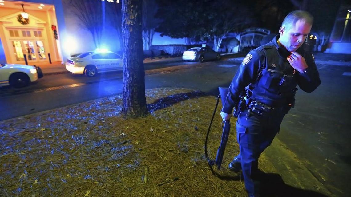 Memphis police officers block off the entrances to the Oak Court Mall on Monday, Dec. 26, 2016, after a disturbance at the mall. Authorities and witnesses say there have been disturbances at two malls in Memphis, Tenn., and one of them had to be shut down.