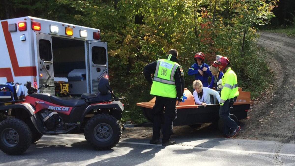 
Emergency first responders assist a woman, center, as she is transferred to an ambulance from a trailer attached to an all-terrain vehicle near the site of an Amtrak train derailment, Monday, Oct. 5, 2015, in Roxbury, Vt. 
