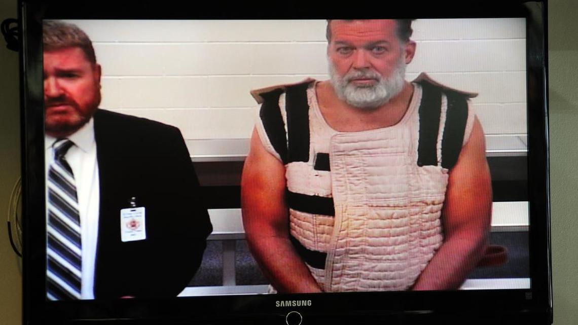 Colorado Springs Planned Parenthood shooting suspect Robert Dear, right, appears via video before Judge Gilbert Martinez, with public defender Dan King, at the El Paso County Criminal Justice Center.