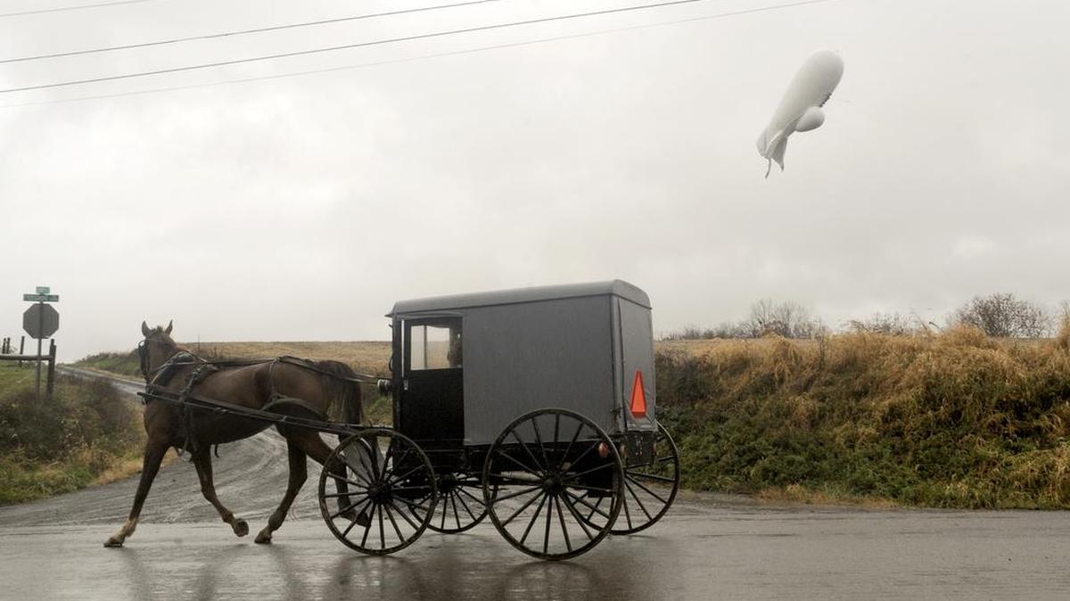 An unmanned Army surveillance blimp that broke loose from its ground tether in Maryland floats at about 1,000 feet while dragging a tether line just south of Millville, Pa., Wednesday, Oct. 28, 2015.