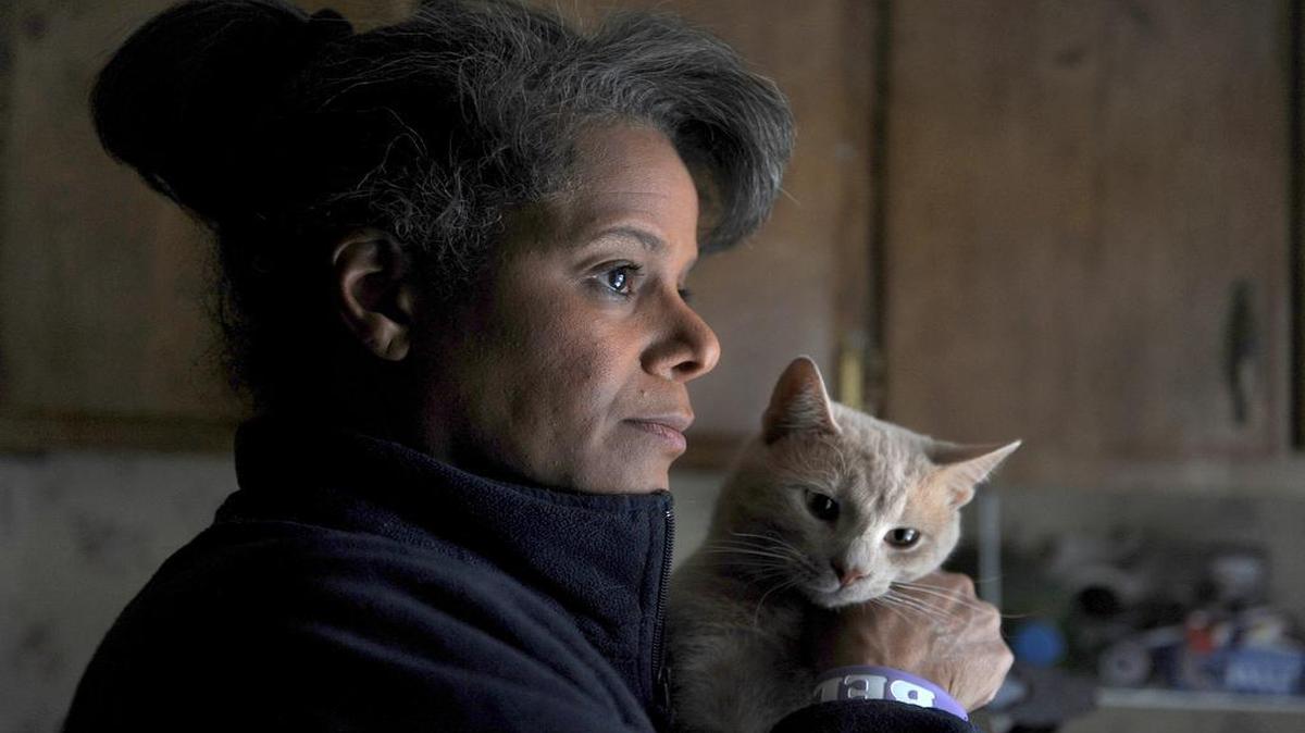 Debi Thomas in her mobile home in Richlands, Virginia, with her cat, Sylvester.