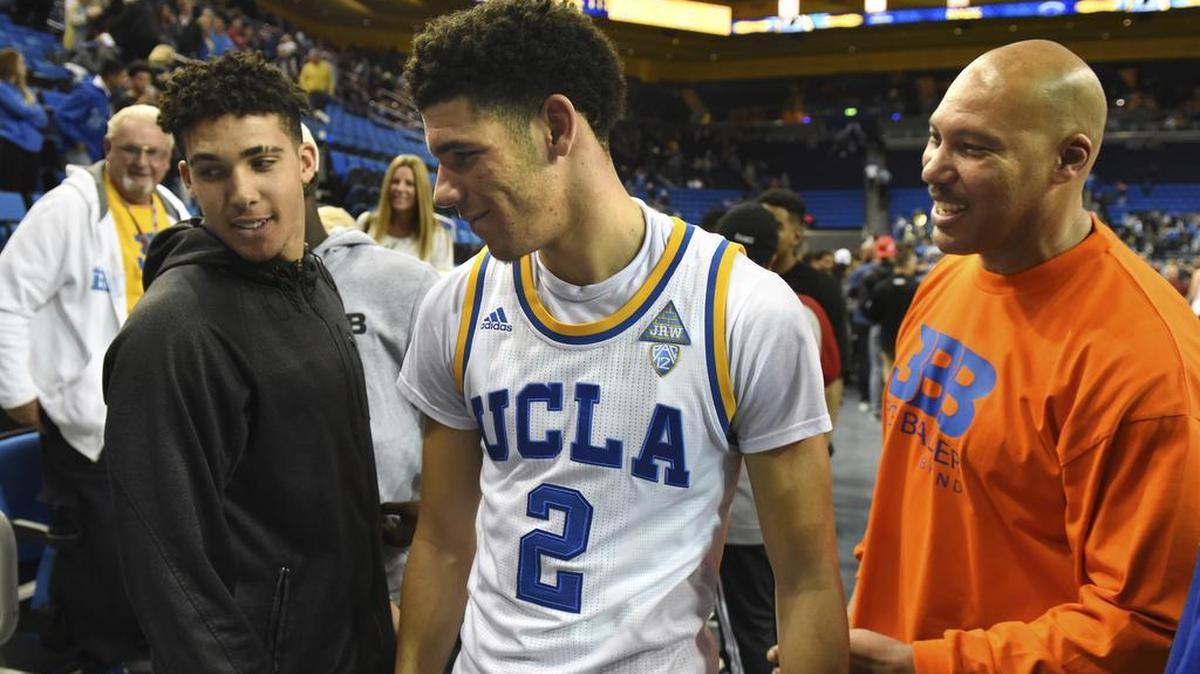 In this Nov. 20, 2016, file photo, UCLA's Lonzo Ball, center, greets his brother LiAngelo Ball, left, and father LaVar Ball, right, after scoring 20 points in their 114-77 win over Long Beach State at an NCAA college basketball game in Los Angeles. LiAngelo Ball was reportedly arrested Tuesday in Hangzhou, China on shoplifting charges during a team trip with UCLA to open the 2017 season.
