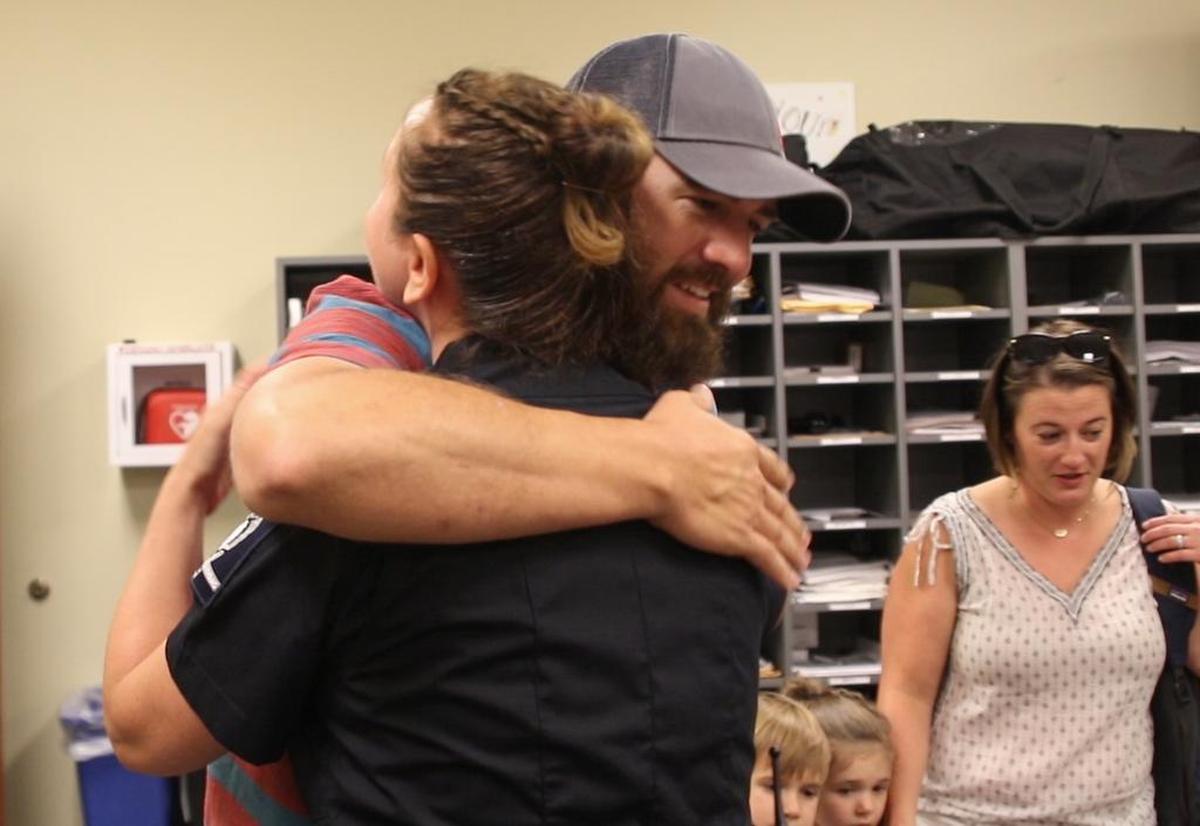 John Ogburn embraces Charlotte Mecklenburg Police Officer Nikolina Bajic on Tuesday. Bajic was one of two officers who first responded when Ogburn went into cardiac arrest at the Panera Bread restaurant in Cotswold Village late last month.