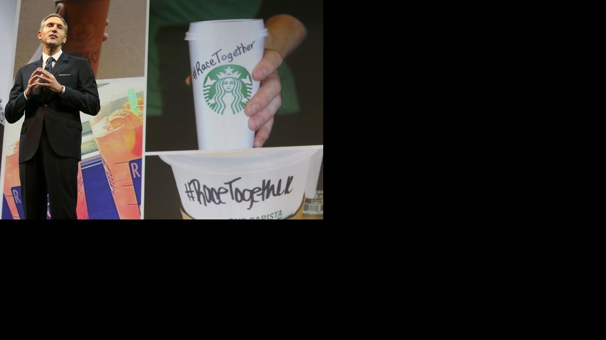 
Starbucks CEO Howard Schultz speaks Wednesday, March 18, 2015, at the coffee company’s annual shareholders meeting in Seattle. To the right is a photo of a coffee cup with #RaceTogether written on it, part of a new company campaign. 
