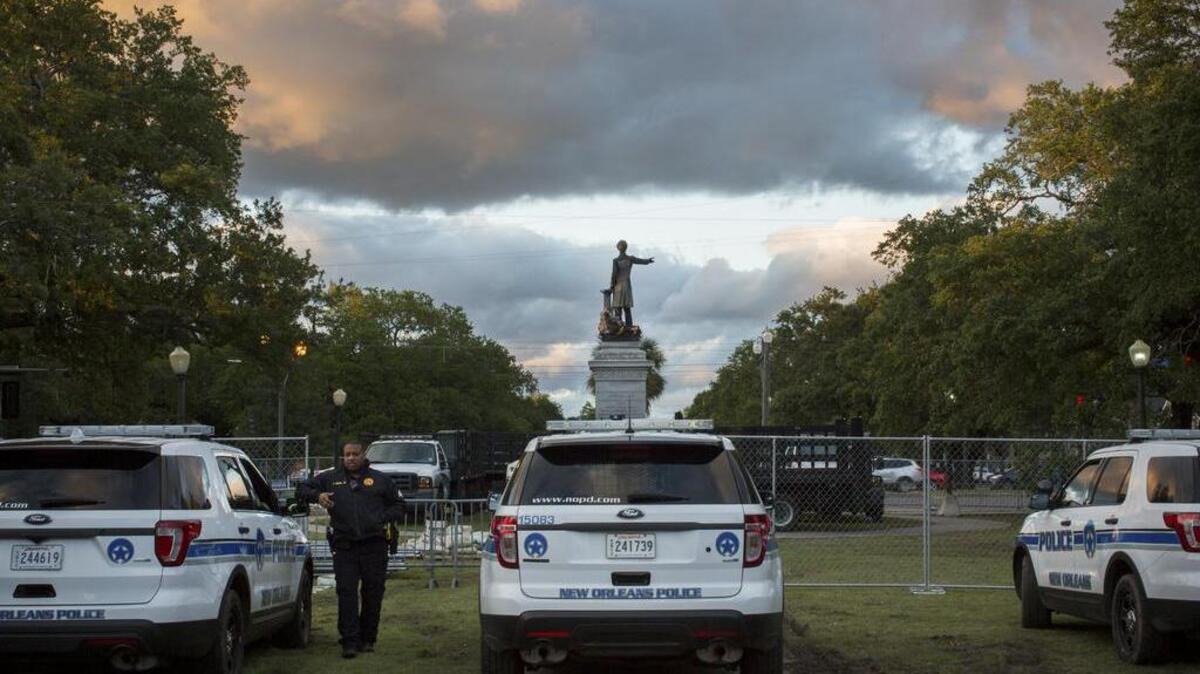 Police officers guard a statue of Jefferson Davis, which the city plans to remove soon, in New Orleans, May 4, 2017. The city has already taken down one Confederate monument, but crane companies in the region are receiving threats over the removal of three others.
