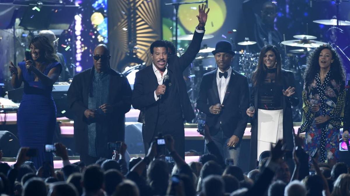 Honoree Lionel Richie performs at the MusiCares Person of the Year tribute at the Los Angeles Convention Center on Saturday, Feb. 13, 2016. Pictured from left are Yolanda Adams, Stevie Wonder, Pharrell Williams, Karen Fairchild and Corinne Bailey Rae.