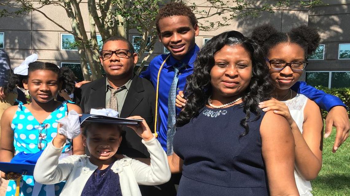 Minaldy Cadet, center, with his parents and three sisters on the day he graduated from St. Thomas Aquinas High School in Fort Lauderdale.