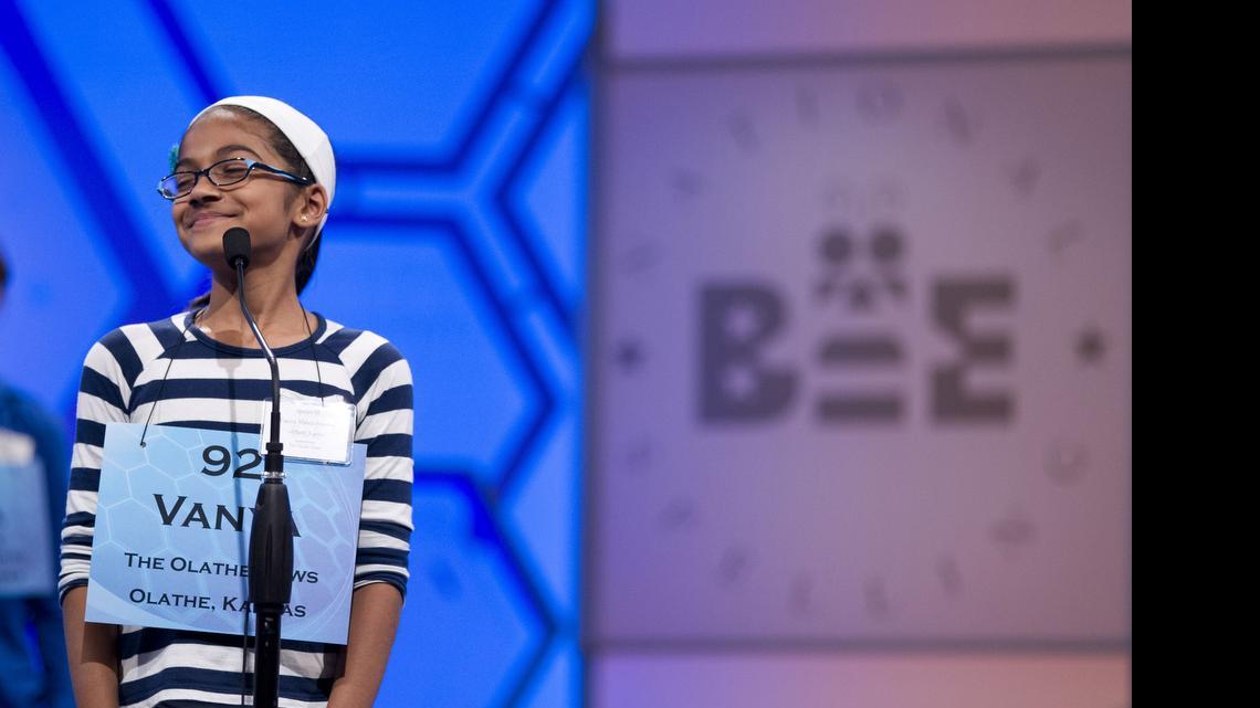 
Vanya Shivashankar, of Olathe, Kansas, smiles as she answers her question during the third round of the National Spelling Bee in Oxon Hill, Maryland, in 2012. Participants and bee officials say the competition is fairer now that kids are tested on what words mean. But it’s also taken some of the drama away from the semifinal rounds. Thirteen-year-old Vanya Shivashankar says she misses the simplicity of the old format, which she called “spelling till you drop.” Now, there are two semifinal rounds, and test scores determine who makes it to the finals. Vanya was eliminated at that stage last year.
