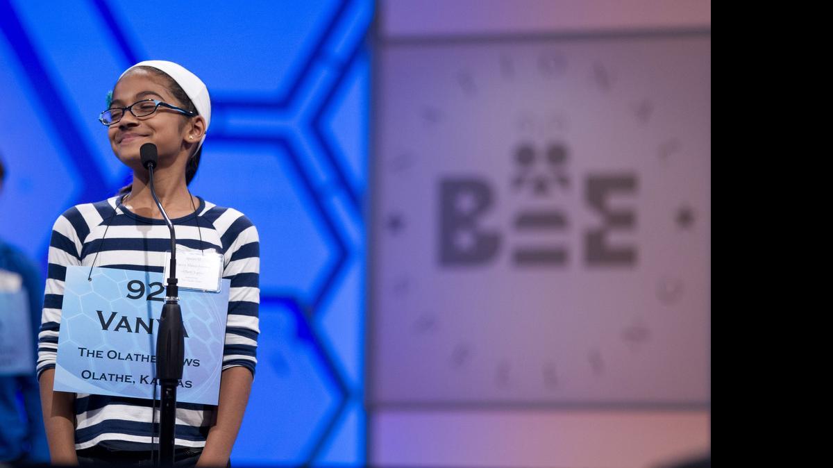 
Vanya Shivashankar, of Olathe, Kansas, smiles as she answers her question during the third round of the National Spelling Bee in Oxon Hill, Maryland, in 2012. Participants and bee officials say the competition is fairer now that kids are tested on what words mean. But it’s also taken some of the drama away from the semifinal rounds. Thirteen-year-old Vanya Shivashankar says she misses the simplicity of the old format, which she called “spelling till you drop.” Now, there are two semifinal rounds, and test scores determine who makes it to the finals. Vanya was eliminated at that stage last year.
