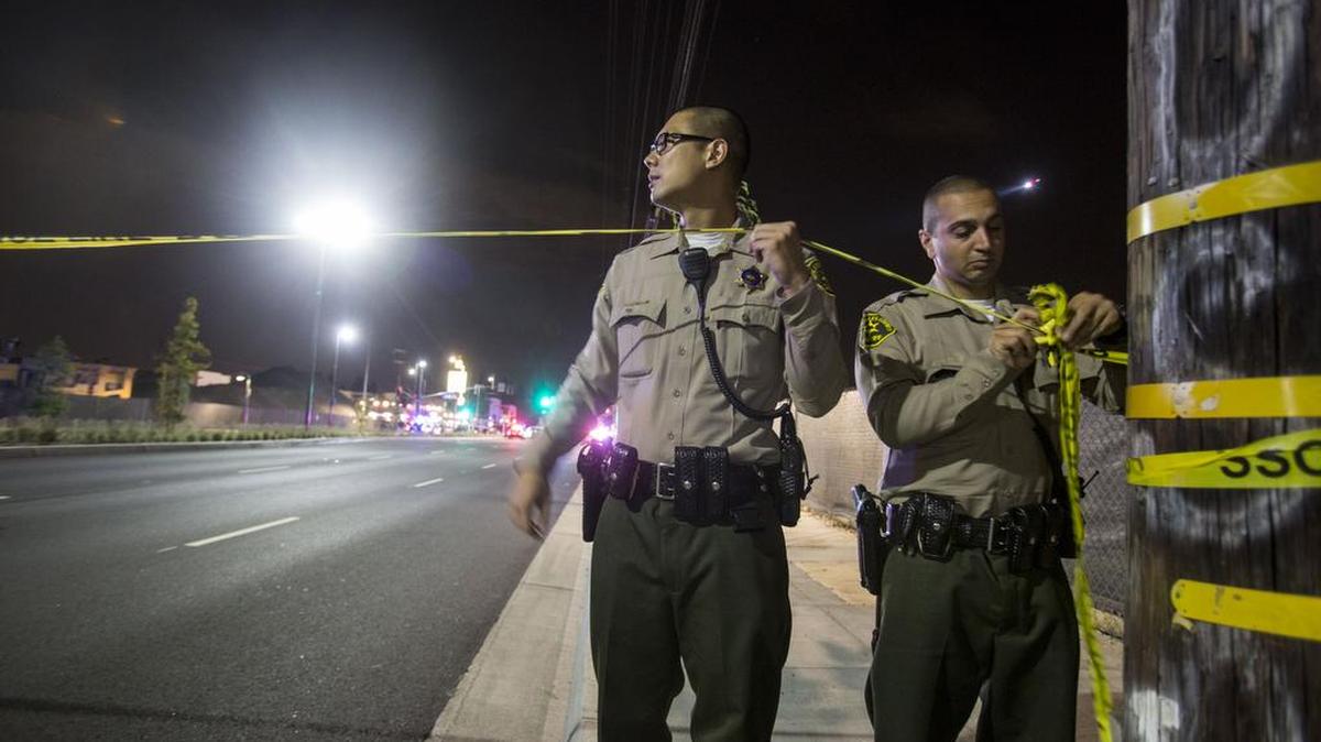 
Police officers put up yellow tape outside of Chris and Pitt’s Barbecue restaurant in Downey, Calif., after SWAT officers killed an armed carjacking suspect who led officers and deputies on a high-speed chase before running inside the eatery.

